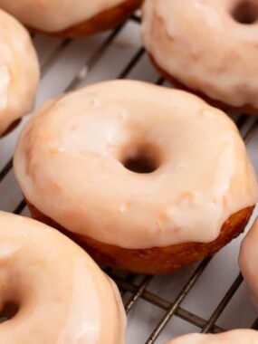Maple glaze donuts on a cooling rack.