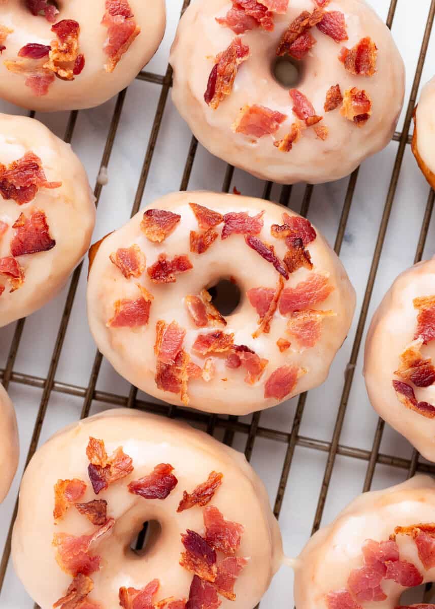 Maple bacon donuts on a cooling rack.