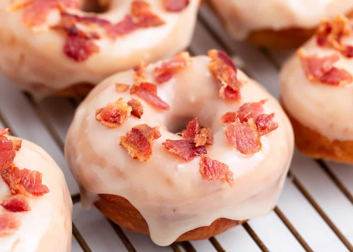 Maple bacon donut on a cooling rack.