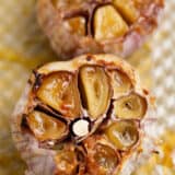 Roasted garlic on a baking sheet.