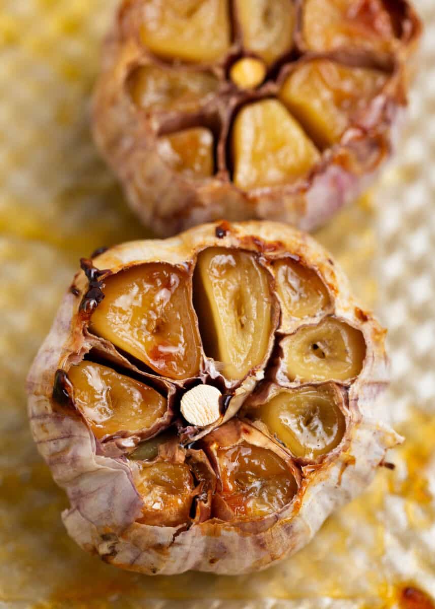 Roasted garlic on a baking sheet.