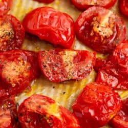 Roasted tomatoes on the baking sheet.