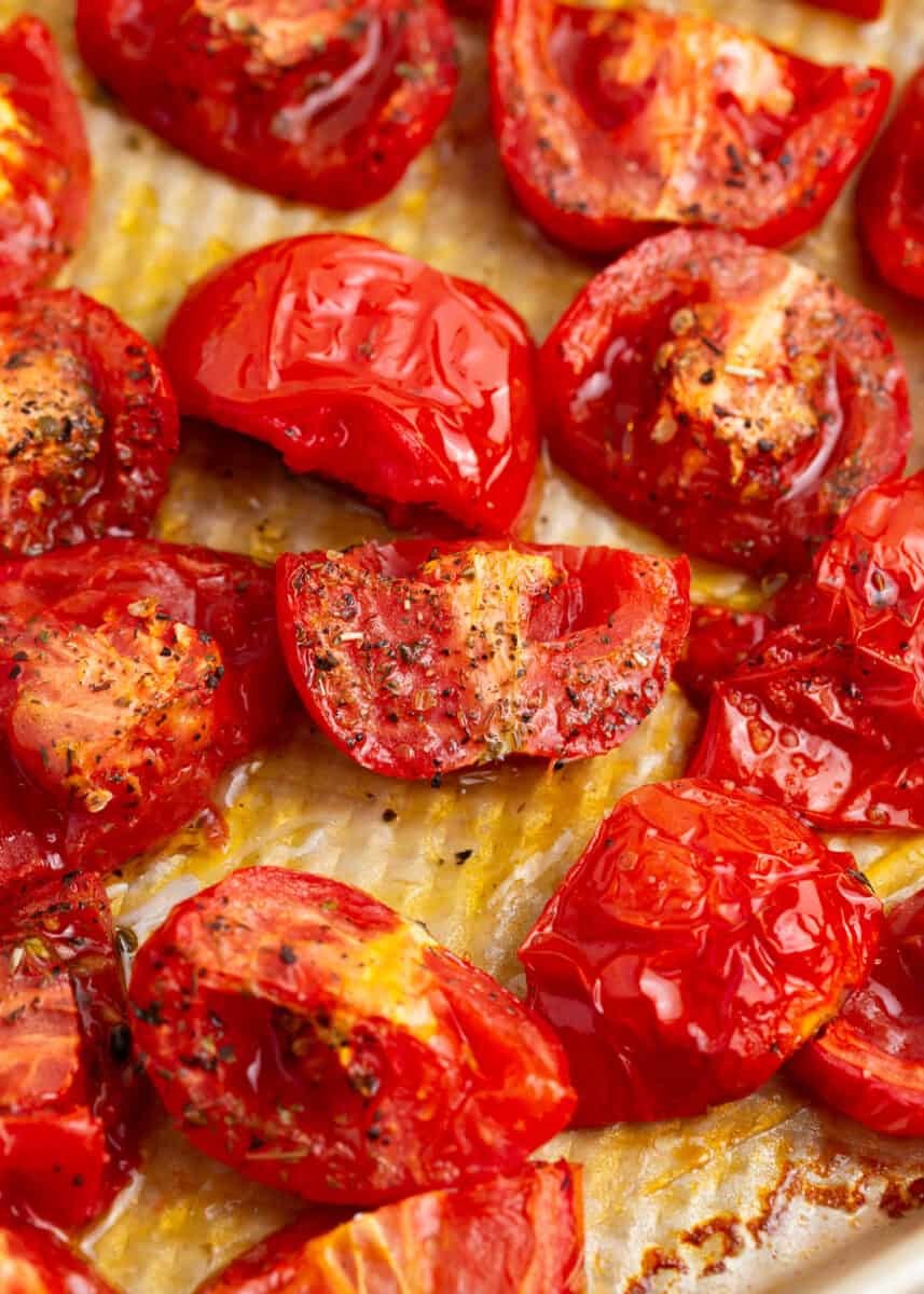 Roasted tomatoes on the baking sheet.