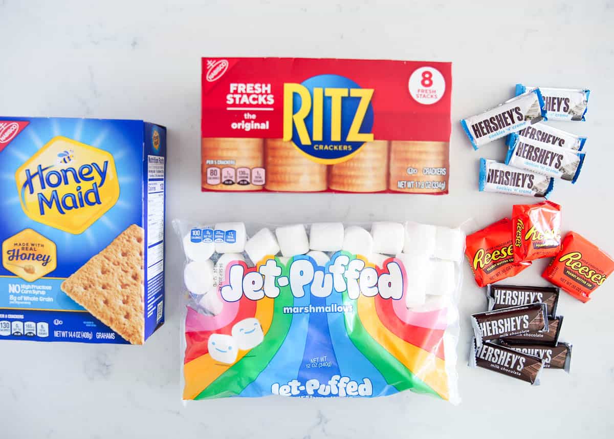 S'mores ingredients on marble counter.