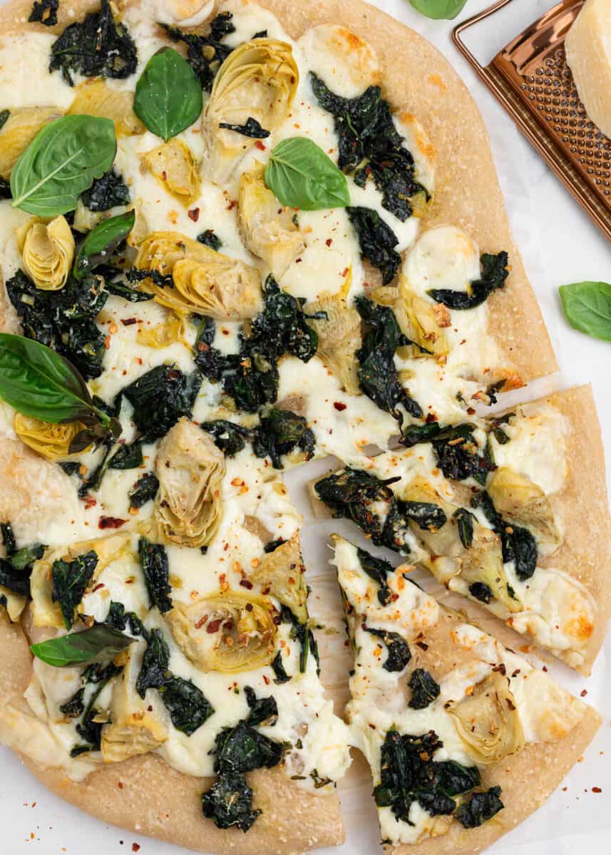 Sliced spinach artichoke pizza.