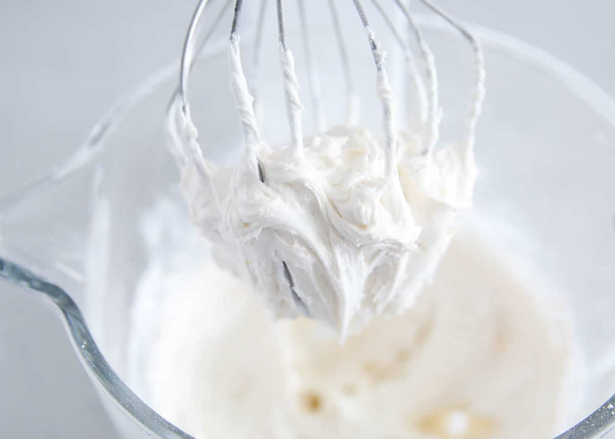 Vanilla frosting on a whisk.