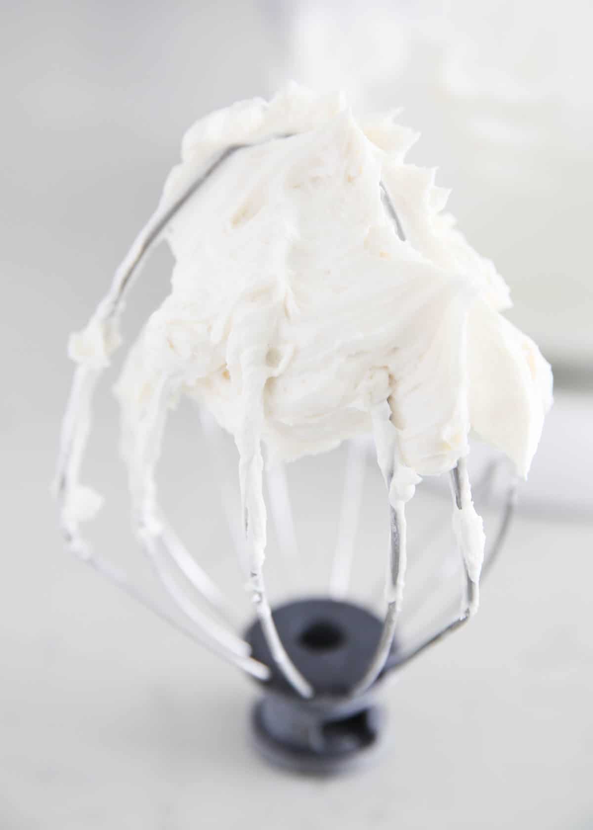 Vanilla frosting on a blender whisk.