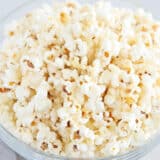 White cheddar popcorn in glass bowl.