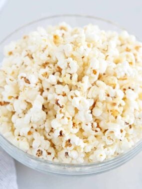 White cheddar popcorn in glass bowl.