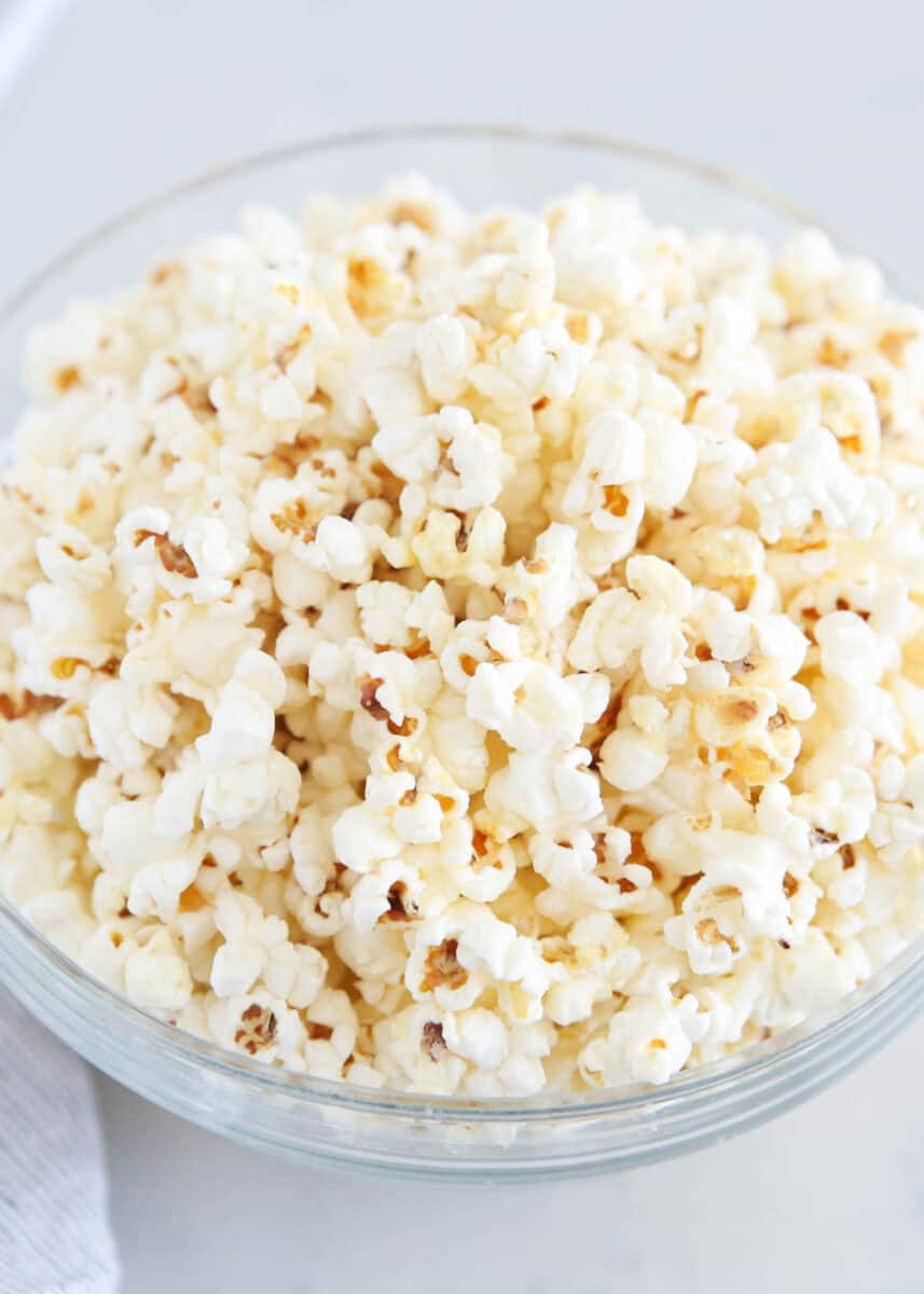 White cheddar popcorn in glass bowl.