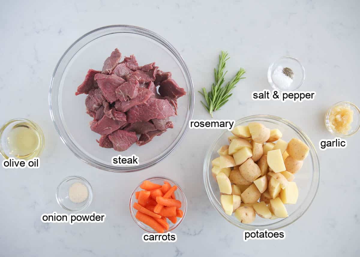 Steak and potato foil pack ingredients on countertop.