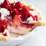 Slice cut out of strawberry cream pie.