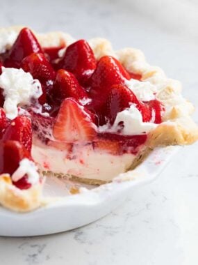 Slice cut out of strawberry cream pie.