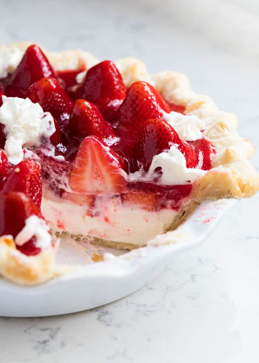 Slice cut out of strawberry cream pie.