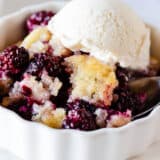 Blackberry cobbler in a white bowl.