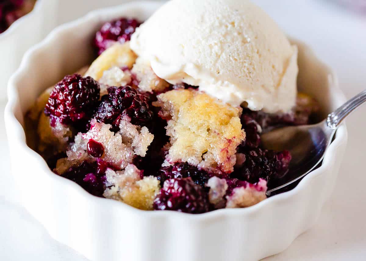 Blackberry cobbler in a white bowl.