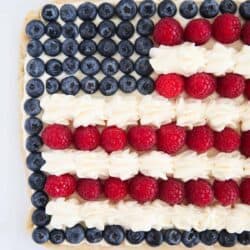 Flag fruit pizza on white plate.