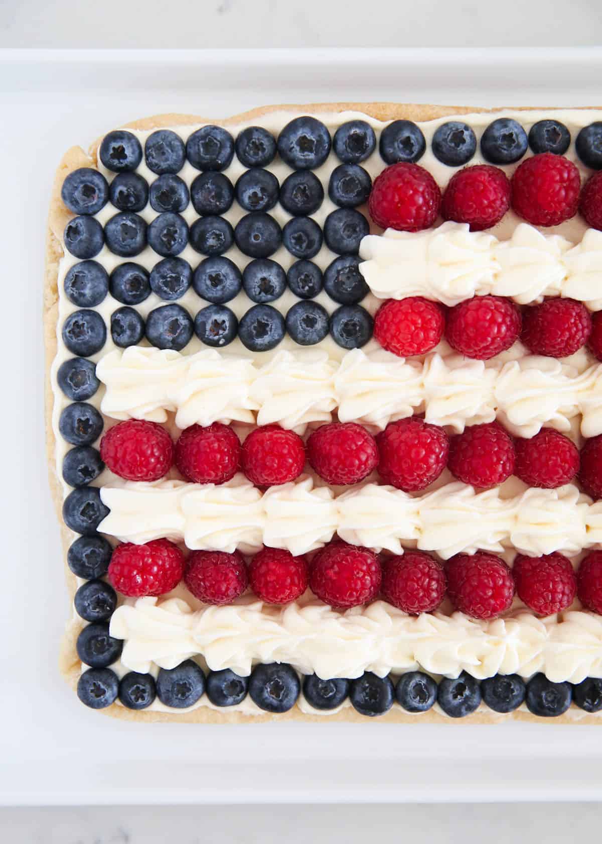 Flag fruit pizza on white plate.