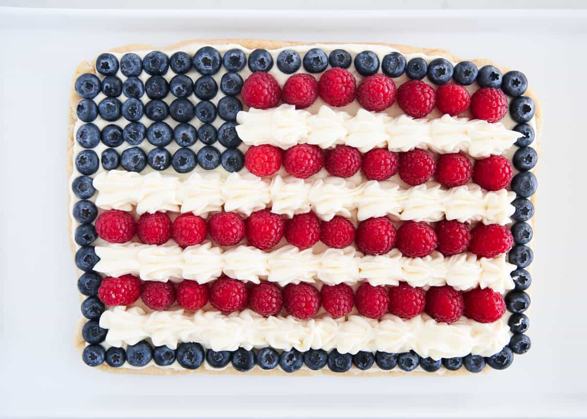 4th of July fruit pizza on white plate.