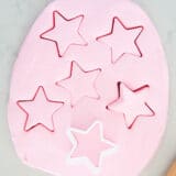 Edible playdough with star cookie cutter on marble counter.