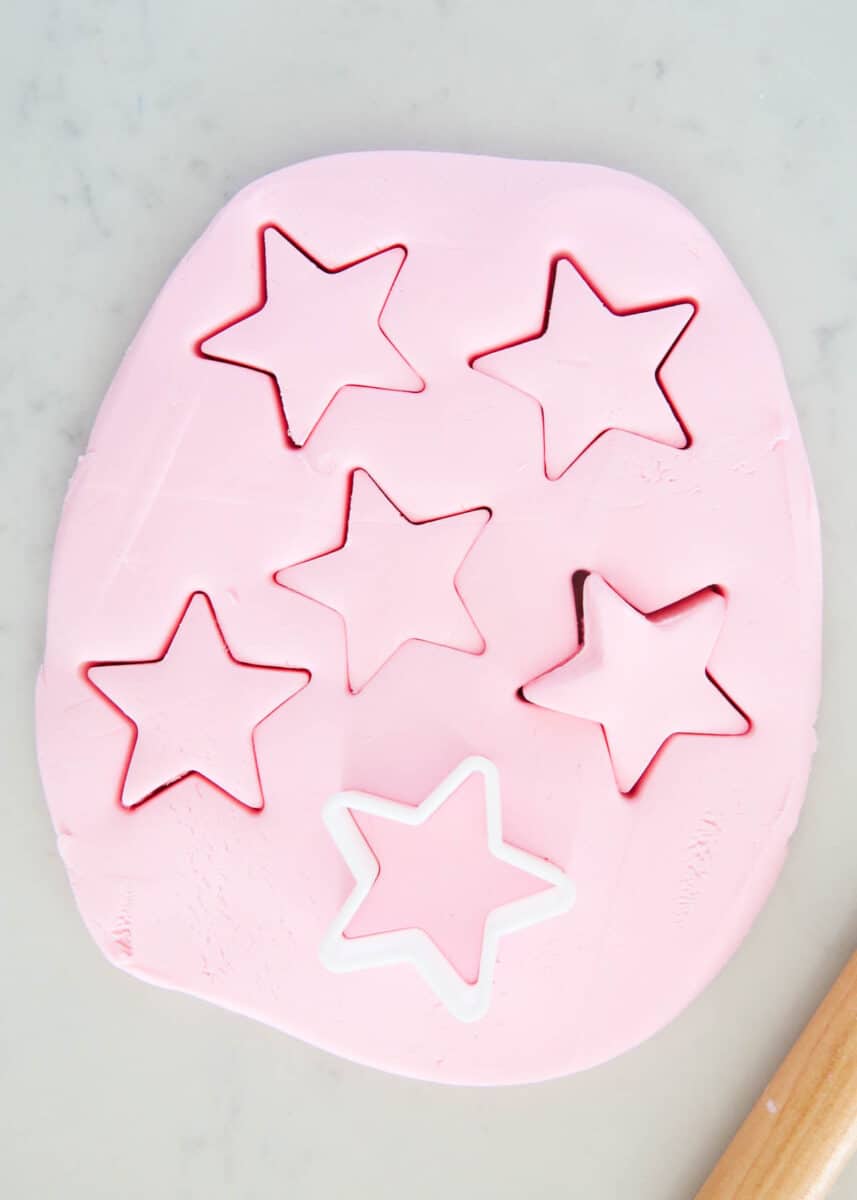 Edible playdough with star cookie cutter on marble counter.