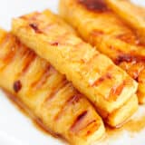 Grilled pineapple slices with brown sugar glaze.