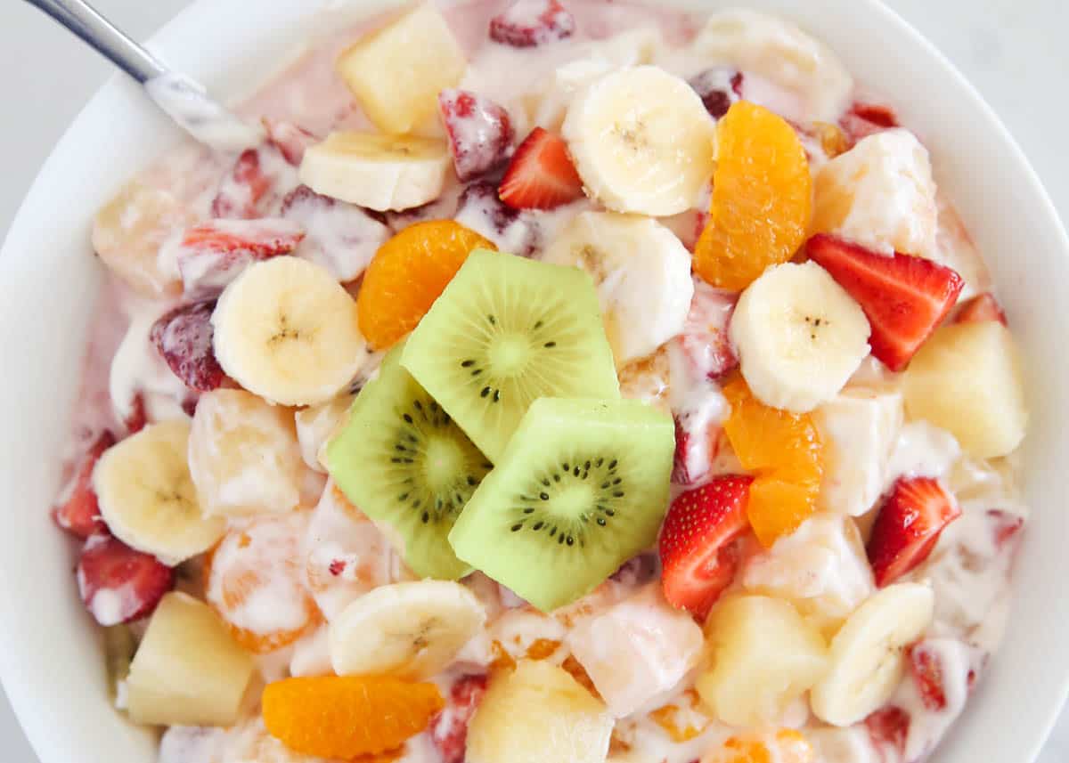 Hawaiian fruit salad in a white bowl.