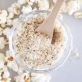 Homemade popcorn seasoning in a glass bowl on the counter.