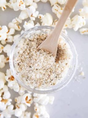 Homemade popcorn seasoning in a glass bowl on the counter.