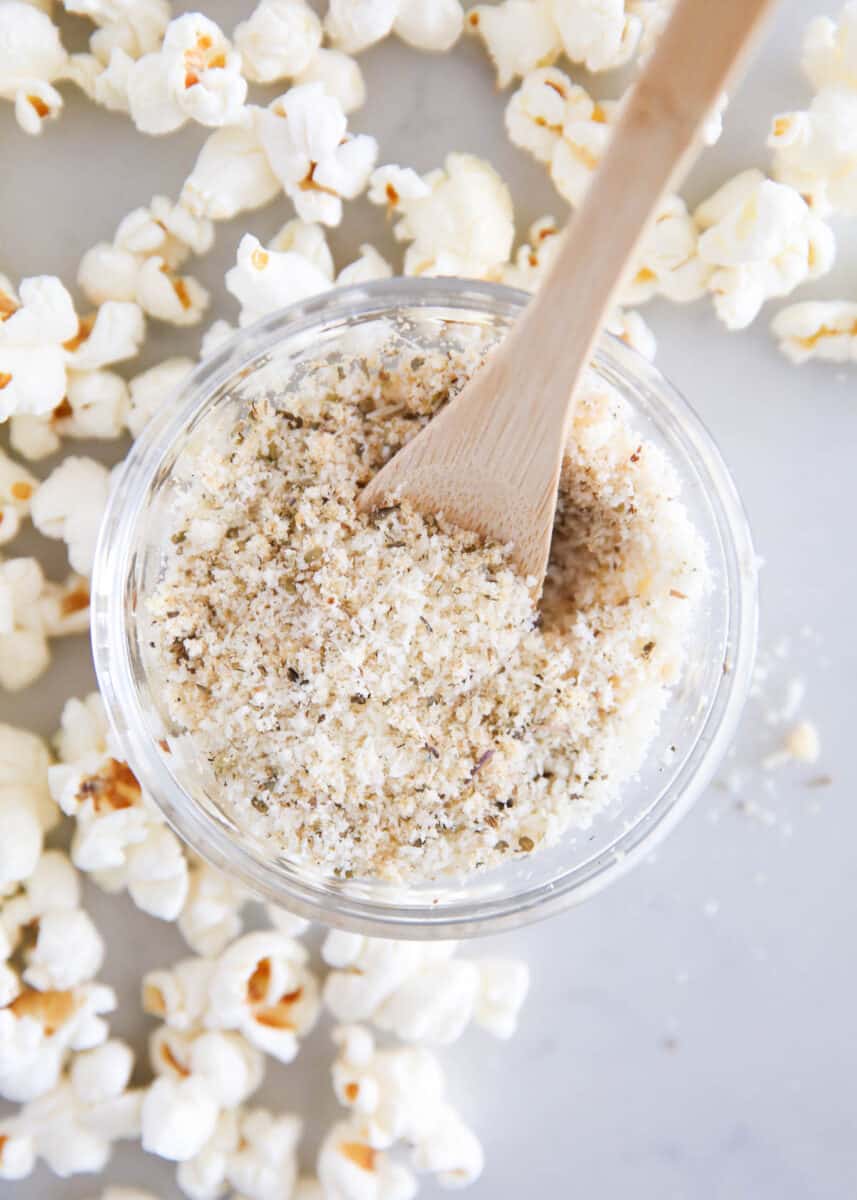 Homemade popcorn seasoning in a glass bowl on the counter.