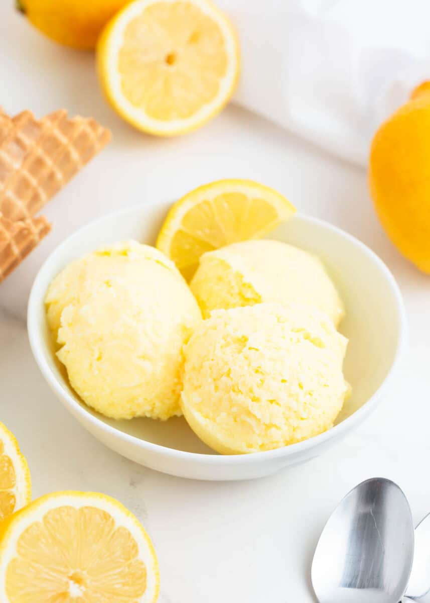 Lemon ice cream in a bowl on counter.