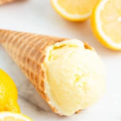 Lemon ice cream cone on marble counter.