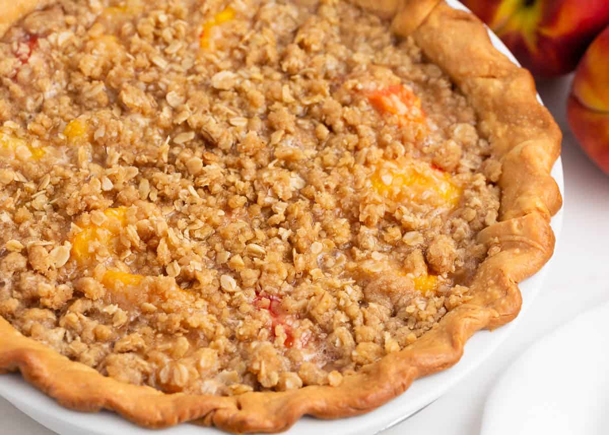 Peach crumble pie on counter.