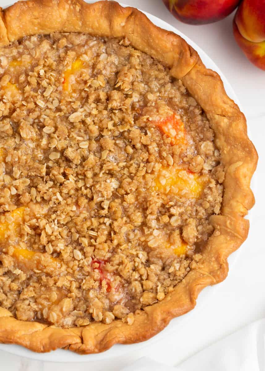 Peach crumble pie on top of counter.