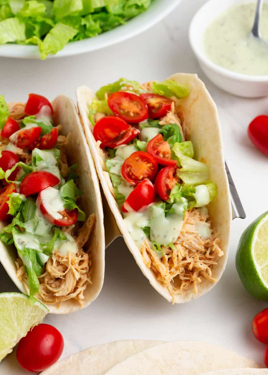 Chicken tacos with lettuce and tomatoes.