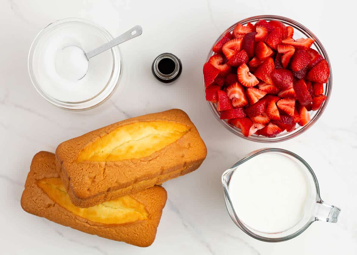 Strawberry shortcake trifle ingredients on counter. 