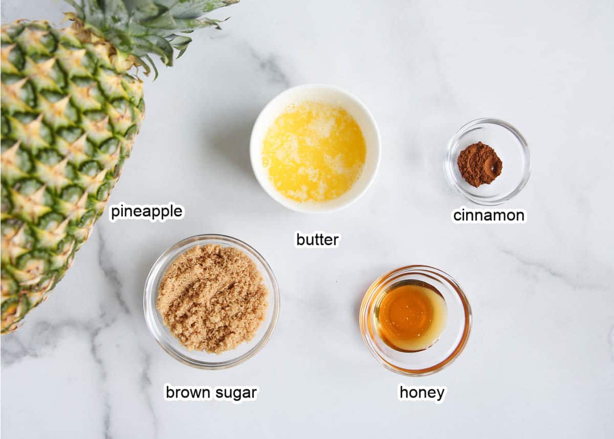 Grilled pineapple ingredients on marble counter.