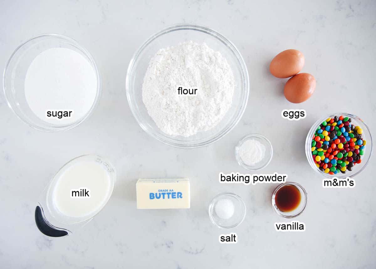 M&M cupcake ingredients on marble counter.