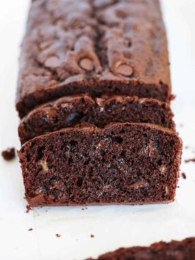 Sliced chocolate banana bread on parchment paper.
