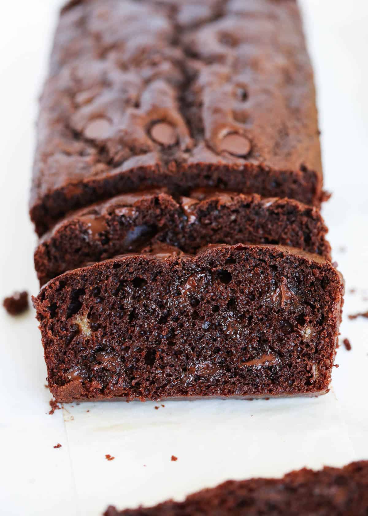 Sliced chocolate banana bread on parchment paper.