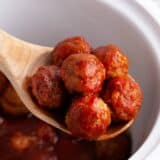 Spoonful of grape jelly chili sauce meatballs.