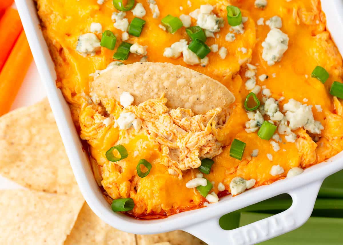 Baked buffalo chicken dip in white baking dish.