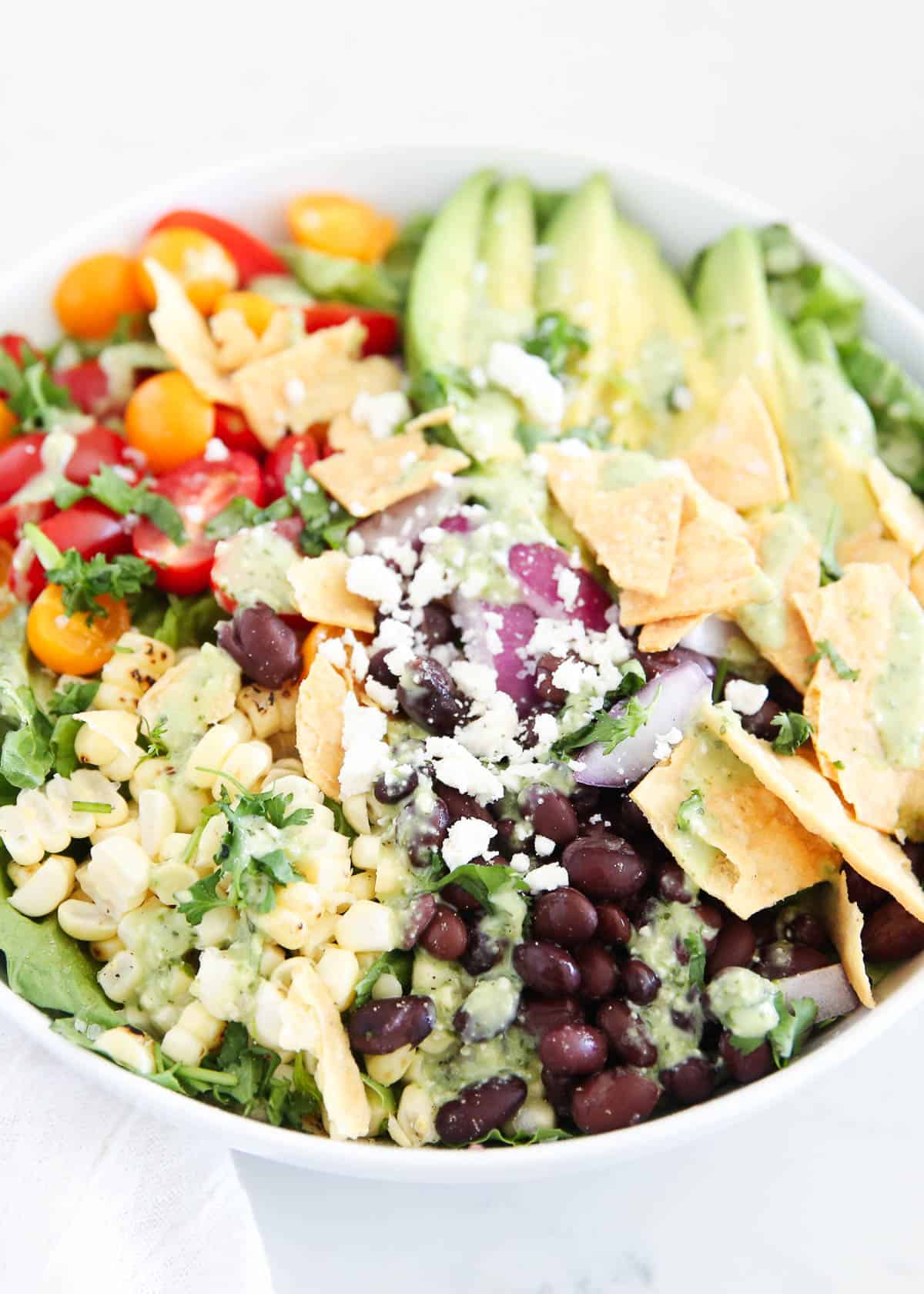 Close up of Mexican salad with black beans, corn and tortilla strips. 