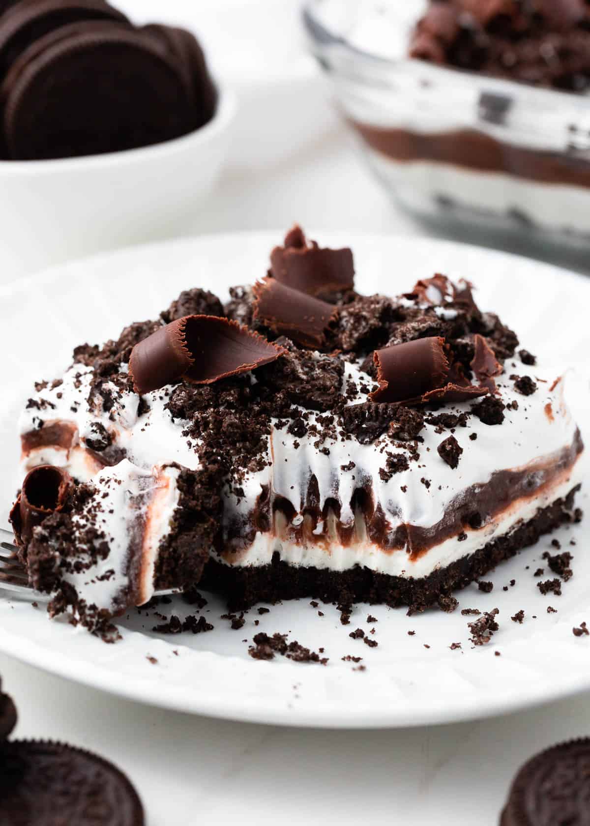 Oreo chocolate lasagna on a white plate.