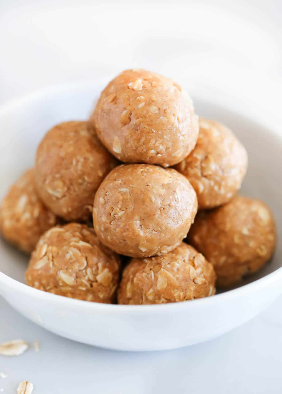 No bake peanut butter oatmeal balls in a white bowl.