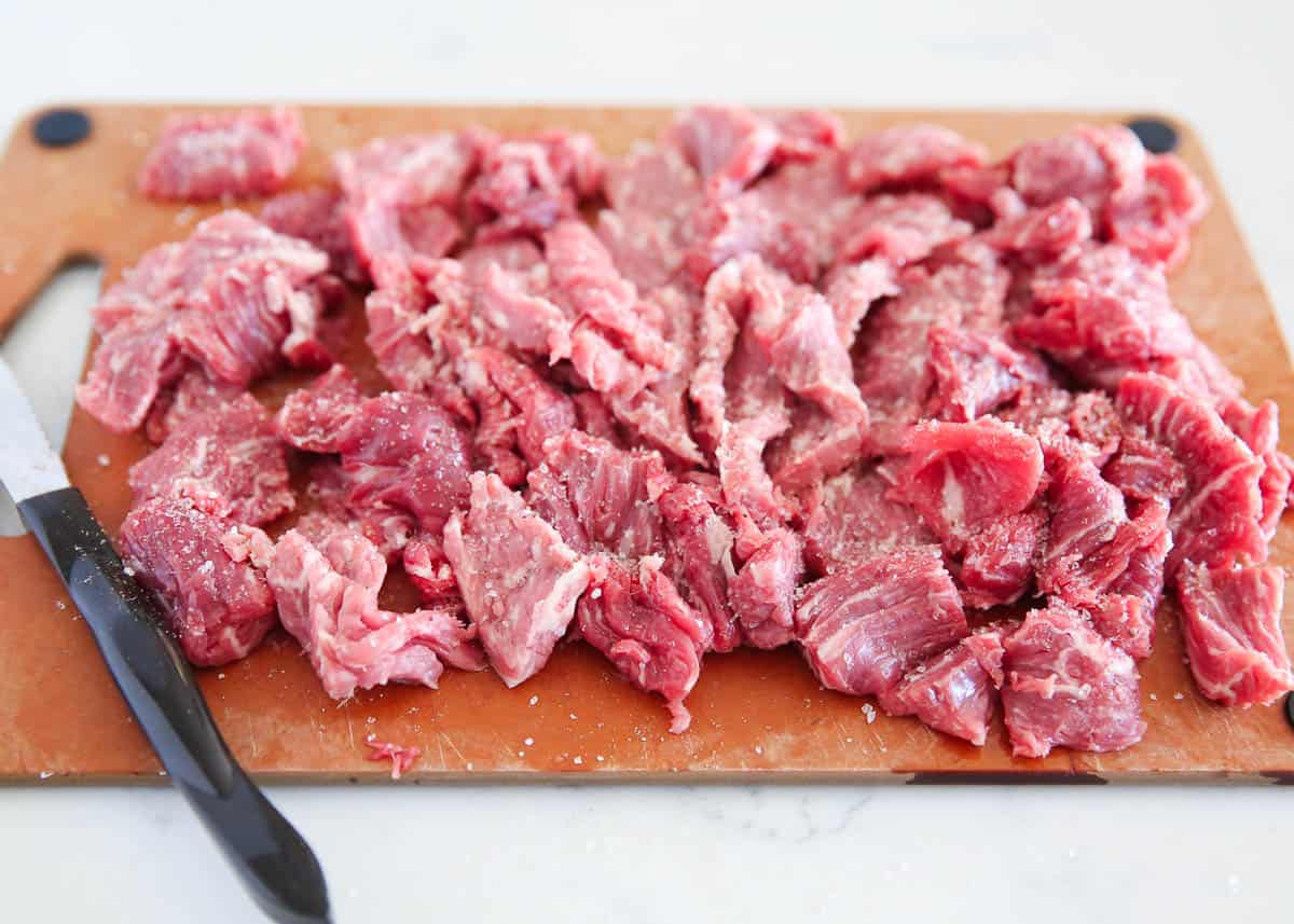 Sliced steak on cutting board.