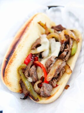 Easy Philly cheesesteak on a toasted hoagie roll with melted provolone and saut&eacute;ed peppers and onions.