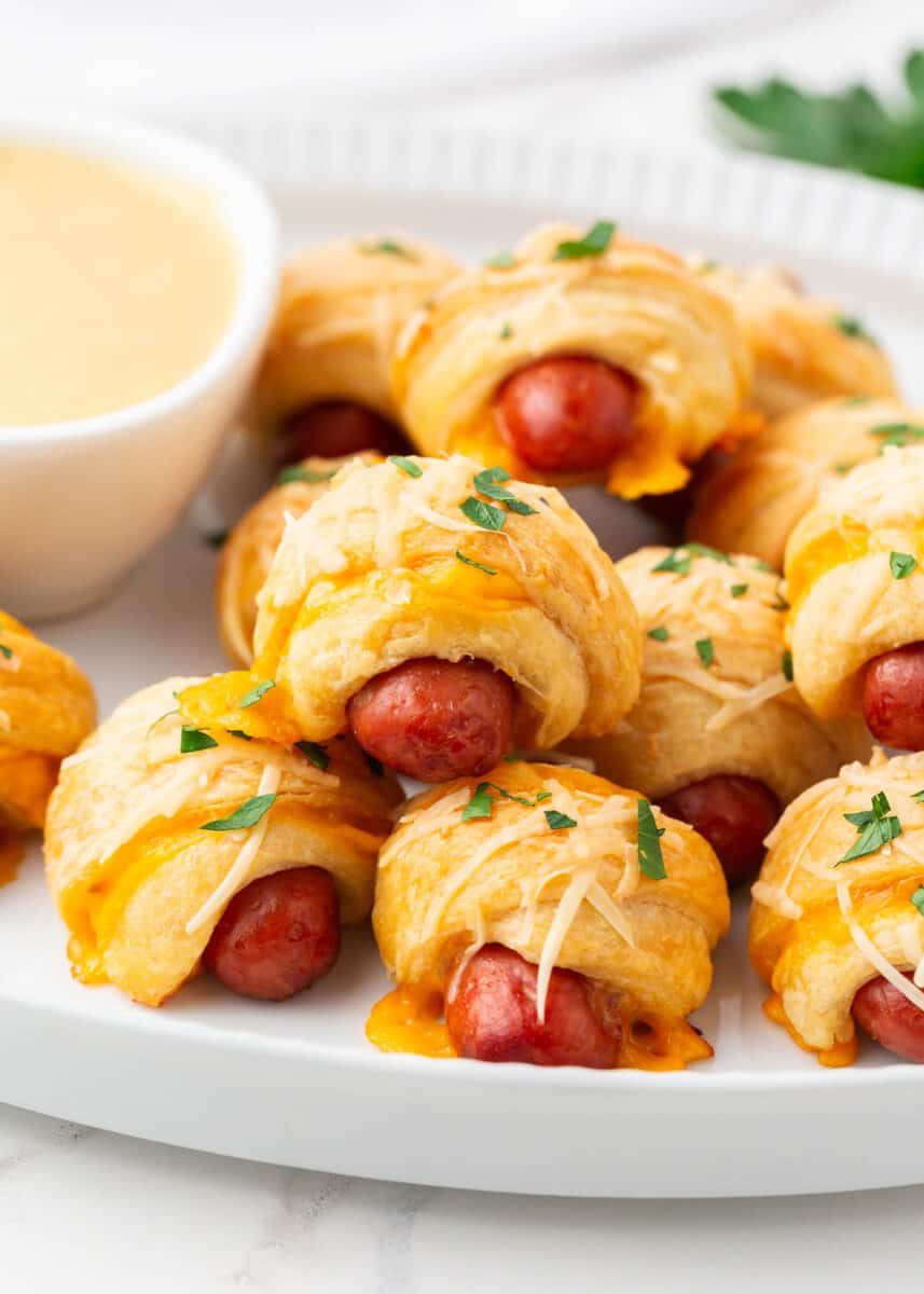 Pigs in a blanket with cheese on top.