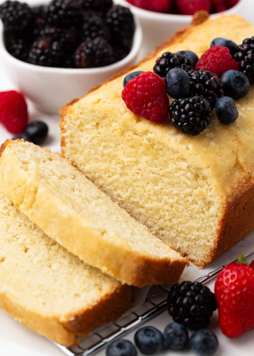 Slice of pound cake with berries on the top.