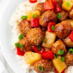 Sweet and sour meatballs and pineapple and rice in a bowl.
